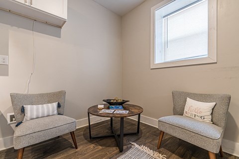 a living room with two chairs and a coffee table at Georgian Oaks Apartments, Smyrna